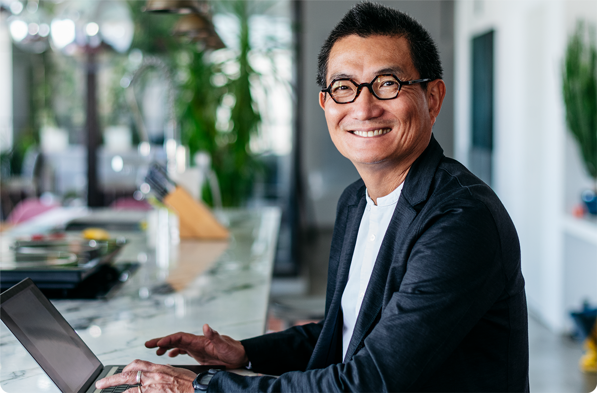 Business man smiling at laptop